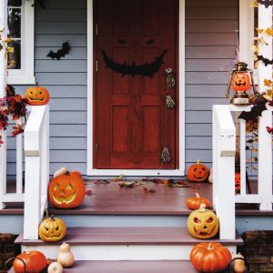 Halloween Decor Ideas for A Spooky Home: photo shows pumpkings lining the steps of a spooky home